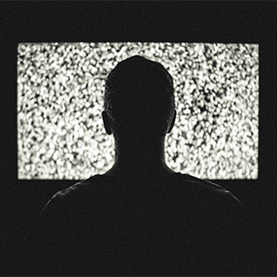 man in front of tv showing static